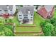 Aerial shot of the back of the house featuring a nice back yard, a deck, and a walkout basement at 5770 Bridleton Xing, Suwanee, GA 30024