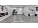 Large basement space features a modern fireplace, a computer desk, and cozy reading nooks at 5770 Bridleton Xing, Suwanee, GA 30024