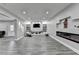 Finished basement features modern lighting, fireplace, and plenty of seating at 5770 Bridleton Xing, Suwanee, GA 30024