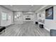The finished basement has recessed lights, lots of room, cozy seating, and a modern fireplace at 5770 Bridleton Xing, Suwanee, GA 30024