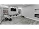 Relaxing basement with sleek lighting, fireplace and built-in bookshelves at 5770 Bridleton Xing, Suwanee, GA 30024