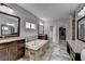 Bright bathroom with tiled floors, soaking tub, granite countertops, and double sink vanity at 5770 Bridleton Xing, Suwanee, GA 30024