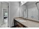 Bathroom featuring a vanity with granite countertop, sink, and modern fixtures at 5770 Bridleton Xing, Suwanee, GA 30024