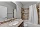 Bathroom with a granite countertop vanity, shower, and modern fixtures at 5770 Bridleton Xing, Suwanee, GA 30024