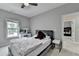 Bedroom featuring a comfortable bed, dresser, and natural light from the windows at 5770 Bridleton Xing, Suwanee, GA 30024