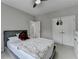 Bedroom featuring a cozy bed, and view of walk in closets and additional doors at 5770 Bridleton Xing, Suwanee, GA 30024