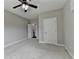 Spacious bedroom with light colored walls, trim, carpet, ceiling fan, and a view at 5770 Bridleton Xing, Suwanee, GA 30024