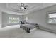 Spacious bedroom with a trey ceiling, neutral paint, large windows and plush carpet at 5770 Bridleton Xing, Suwanee, GA 30024