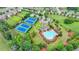 Aerial view of the community pool, clubhouse, tennis courts, and playground at 5770 Bridleton Xing, Suwanee, GA 30024