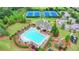 Aerial view of the community pool, clubhouse, tennis courts, and playground at 5770 Bridleton Xing, Suwanee, GA 30024