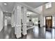 Bright dining room with hardwood floors, decorative pillars, and a modern chandelier at 5770 Bridleton Xing, Suwanee, GA 30024