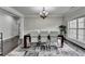 Elegant dining room with hardwood floors, a modern chandelier, and large windows for natural light at 5770 Bridleton Xing, Suwanee, GA 30024