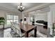 Open dining room boasts dark hardwood floors, modern lighting, with views to the living room at 5770 Bridleton Xing, Suwanee, GA 30024