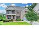 Charming two-story home with brick facade, covered porch, dormers, and landscaped yard at 5770 Bridleton Xing, Suwanee, GA 30024