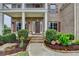 Charming brick home with a covered front porch, mature landscaping, and a welcoming entrance at 5770 Bridleton Xing, Suwanee, GA 30024