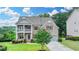 Beautiful two-story brick home with a well-manicured lawn, a front porch, and a driveway at 5770 Bridleton Xing, Suwanee, GA 30024