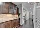 Hallway with hardwood floors, dark wood cabinetry, and decorative columns at 5770 Bridleton Xing, Suwanee, GA 30024