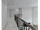 Hallway features black wrought iron railing, neutral walls, and a view of the downstairs living area at 5770 Bridleton Xing, Suwanee, GA 30024