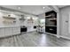 Modern kitchen with white cabinets, stainless steel appliances, open shelving and stone countertops at 5770 Bridleton Xing, Suwanee, GA 30024