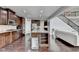 Open kitchen with dark wood cabinets, stainless appliances, granite countertops, and hardwood floors at 5770 Bridleton Xing, Suwanee, GA 30024