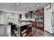 Open kitchen with stainless steel appliances, a large island, and dark wood cabinets at 5770 Bridleton Xing, Suwanee, GA 30024