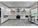 Bright kitchen features stainless steel appliances, white cabinets, and floating wood shelves at 5770 Bridleton Xing, Suwanee, GA 30024