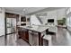 Spacious kitchen with a large island, hardwood floors, stainless steel appliances, and opens to the living room at 5770 Bridleton Xing, Suwanee, GA 30024