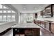 Spacious kitchen featuring granite counters, a large island, stainless appliances, and beautiful dark hardwood flooring at 5770 Bridleton Xing, Suwanee, GA 30024