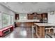 Kitchen with large island, granite countertops, seating, hardwood floors, and dark wood cabinetry at 5770 Bridleton Xing, Suwanee, GA 30024