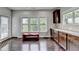 Bright kitchen with dark wood floors, cabinets, granite countertops, and a window with views of the trees outside at 5770 Bridleton Xing, Suwanee, GA 30024