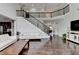 Upstairs landing overlooking a spacious living room with a staircase and hardwood floors at 5770 Bridleton Xing, Suwanee, GA 30024