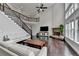 Open concept living room with a fireplace, lots of light, and a view of the upstairs balcony at 5770 Bridleton Xing, Suwanee, GA 30024