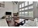 Bright living room with a stone fireplace, high ceilings, and abundant natural light at 5770 Bridleton Xing, Suwanee, GA 30024