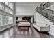 Open floor plan featuring a living room, hardwood floors, staircase, and a view of the kitchen at 5770 Bridleton Xing, Suwanee, GA 30024