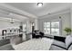Inviting living room with hardwood floors, large windows, and an open layout to dining area at 5770 Bridleton Xing, Suwanee, GA 30024