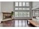 Inviting living room featuring a stone fireplace, hardwood floors, and lots of natural light at 5770 Bridleton Xing, Suwanee, GA 30024