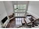 Bright open-concept living room with soaring windows, beautiful dark floors, and fireplace at 5770 Bridleton Xing, Suwanee, GA 30024
