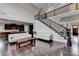 Bright living room with hardwood floors, staircase, and open access to the kitchen at 5770 Bridleton Xing, Suwanee, GA 30024
