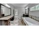 Luxury bathroom featuring a soaking tub, double vanity, granite countertops, and neutral tiling at 5770 Bridleton Xing, Suwanee, GA 30024