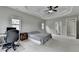 Spacious bedroom featuring tray ceiling, ample natural light, and doorway to the ensuite bathroom at 5770 Bridleton Xing, Suwanee, GA 30024