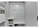 Mudroom with white bench, storage, hooks, and a space for storing shoes and other items at 5770 Bridleton Xing, Suwanee, GA 30024