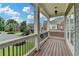 Covered porch with stylish columns and wood flooring providing an inviting outdoor space at 5770 Bridleton Xing, Suwanee, GA 30024
