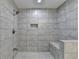 Large walk-in shower with tiled walls and floor, built-in bench, and rainfall shower head at 5770 Bridleton Xing, Suwanee, GA 30024