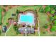 Aerial view of a stunning community pool with lounge chairs and a meticulously landscaped surrounding area at 5770 Bridleton Xing, Suwanee, GA 30024