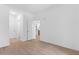 Open bedroom featuring hardwood floors, recessed lighting, and neutral color scheme with easy access to the kitchen at 775 Juniper Ne St # 210, Atlanta, GA 30308