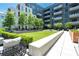 Inviting common area with lush landscaping and comfortable seating, creating a serene and relaxing outdoor environment at 775 Juniper Ne St # 210, Atlanta, GA 30308