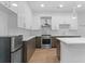 A modern kitchen features sleek white countertops and stainless-steel appliances at 775 Juniper Ne St # 210, Atlanta, GA 30308