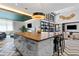 Bright and airy lounge featuring a large island with seating and a cozy fireplace at 775 Juniper Ne St # 210, Atlanta, GA 30308