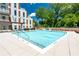 Inviting outdoor pool with clear blue water, surrounded by lush greenery and comfortable lounge areas at 775 Juniper Ne St # 210, Atlanta, GA 30308