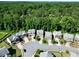 Aerial view of homes in a suburban neighborhood surrounded by lush green trees at 2550 Trelipe Dr, Lawrenceville, GA 30044